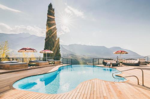 a swimming pool with a view of the mountains at Golserhof in Tirolo