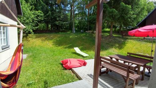 a park with a picnic table and a red bag on the grass at Haus Herrensee Litschau in Litschau