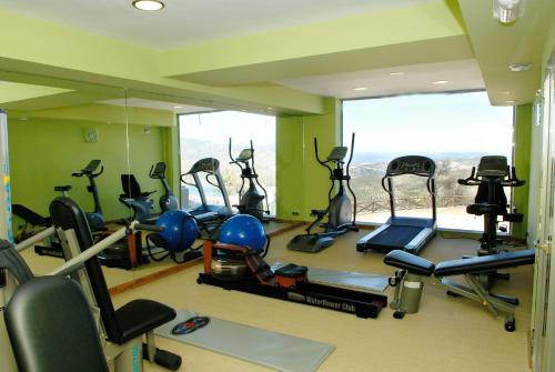 a gym with a bunch of exercise bikes in a room at Hotel Sierra de Cazorla & SPA 3* in Cazorla