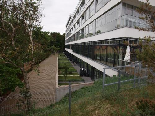 a building with a walkway in front of it at Apartament Dune A 004 in Mielno