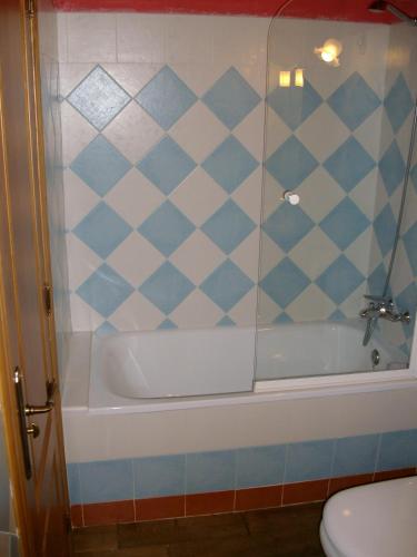 a bathroom with a shower and a tub and a toilet at Casa Rural La Torre de Espinama in Espinama