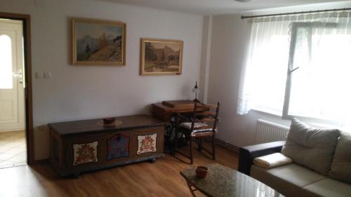 a living room with a couch and a table at Barn House MM in Bled