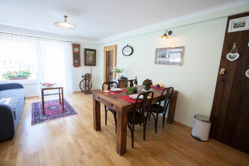a living room with a wooden table and chairs at Barn House MM in Bled