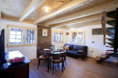 a living room with a table and a couch at Barn House MM in Bled
