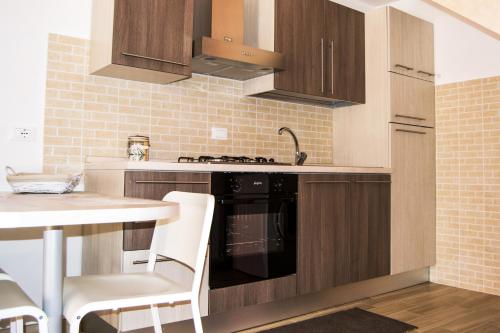 a kitchen with a sink and a stove top oven at Borgo Antico in Portocannone