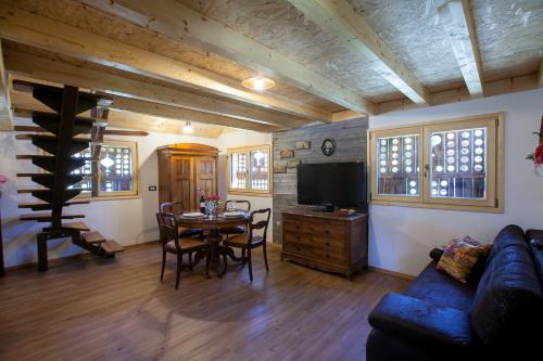 a living room with a blue couch and a table at Barn House MM in Bled