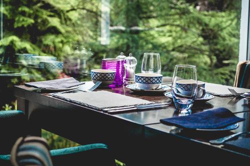 a table with glasses and napkins on top at Tir y Coed Country House in Conwy