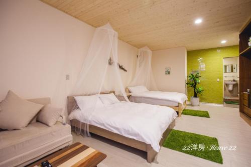 a bedroom with two beds and a couch at House 22 in Kaohsiung