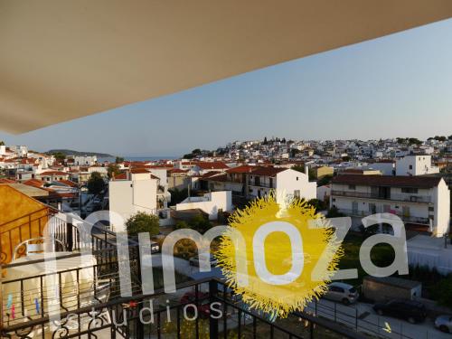a view of a city from the balcony of a building at Mimoza Studios in Skiathos Town