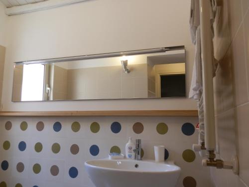 a bathroom with a sink and a mirror at B&B Re Umberto in Milazzo