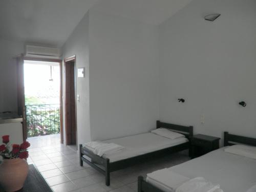 a room with two beds and a window at Mimoza Studios in Skiathos Town