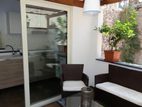 a kitchen with a window and a table and chairs at B&B Re Umberto in Milazzo