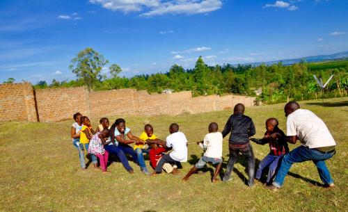 a group of people sitting in a field at Lamanis Haven in Kakamega