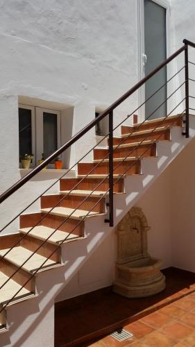 a staircase in a house with wooden rails at La casa di Bice in Cassibile