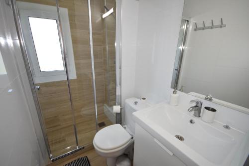 a bathroom with a toilet and a sink and a shower at Castelldefels Playa in Castelldefels