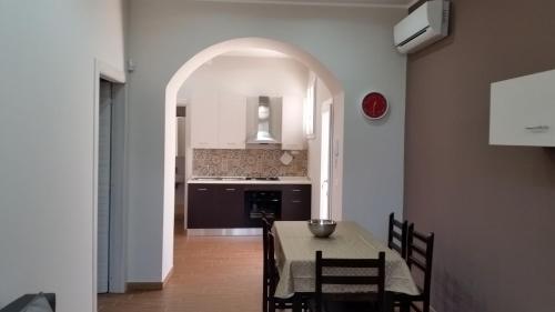 a kitchen with a table and chairs and a kitchen with a table and a kitchen at La casa di Bice in Cassibile