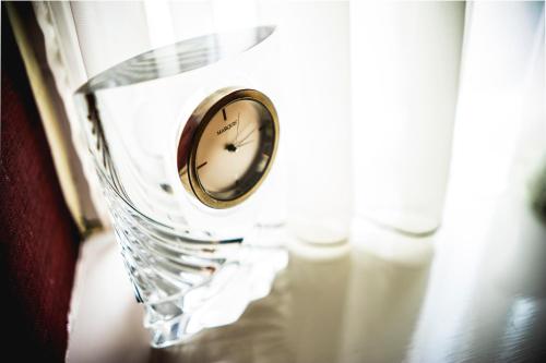 a clock sitting on top of a glass table at Tir y Coed Country House in Conwy