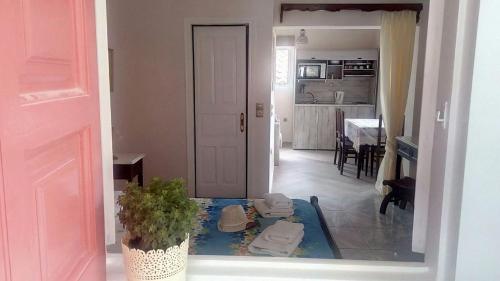 a living room with a table and a kitchen at Eolos Apartments with Private Parking in Agios Nikitas