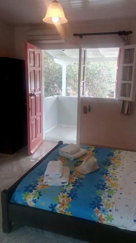 a large bed with three pillows on it in a room at Eolos Apartments with Private Parking in Agios Nikitas