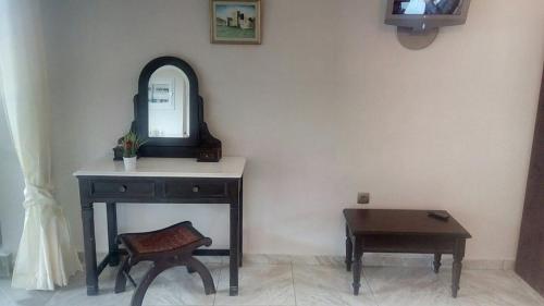 a dressing table with a mirror and a stool at Eolos Apartments with Private Parking in Agios Nikitas