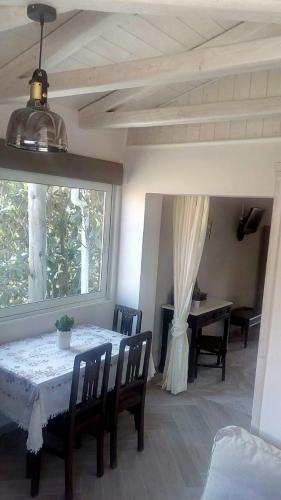 a dining room with a table and chairs and a window at Eolos Apartments with Private Parking in Agios Nikitas