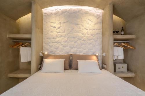 a bed with two white pillows in a room at Villa Adriana Hotel in Agios Prokopios