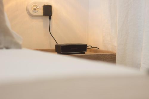 a room with a black phone on a shelf at S'Hotelet d'es Born - Suites & SPA in Ciutadella