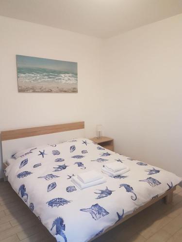 a bed with a blue and white comforter at Apartments Lucija in Senj