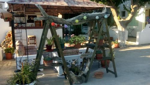 a plant stand with potted plants on it at Skyros Panorama Studios in Skiros