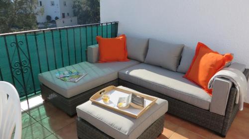 a couch and a coffee table on a balcony at *Casa Anna L'Atzubia in Adsubia