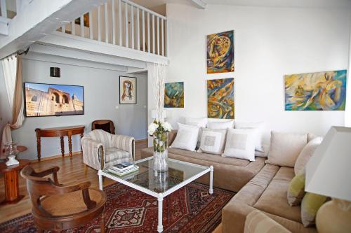 a living room with a couch and a table at Campo Di Fiori, Maisons de Charme in Calvi