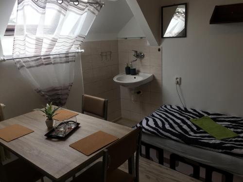a room with a table and a sink in a room at Guesthouse Zuzana in Špačince