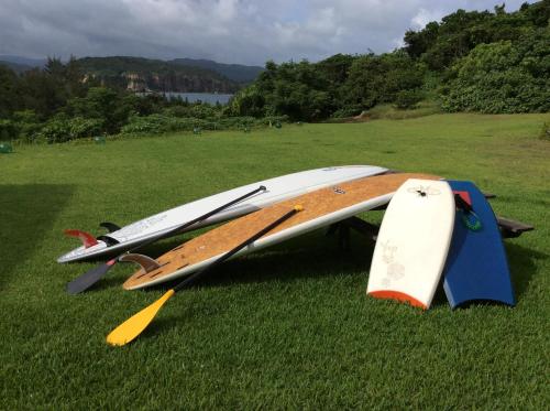 a group of surfboards laying on the grass at Mayagusuku Resort in Iriomote