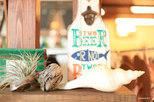 a bottle of alcohol on a table with a skull at PavilionSurf&Lodge in Shishikui
