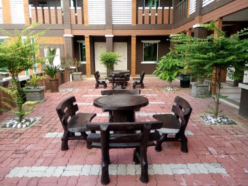 a patio with tables and chairs in a building at Myvilla Langkawi Hotel in Pantai Cenang