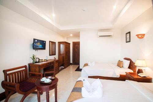 Ein Bett oder Betten in einem Zimmer der Unterkunft Relax Hotel