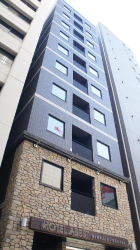 a building in front of a tall building at Hotel SUI Ginza Kyobashi by ABEST in Tokyo