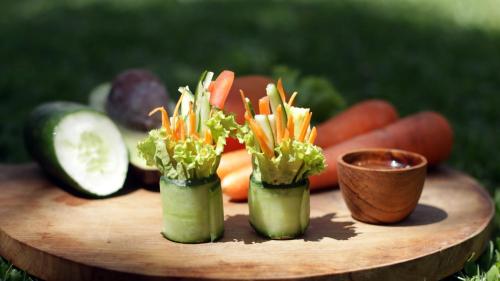 a bunch of vegetables on a wooden cutting board at KajaNe Yangloni at Ubud Bali in Ubud
