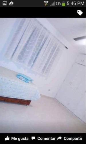 a white refrigerator with a blue object in it at Posada Dilia del Alba in Santo Domingo