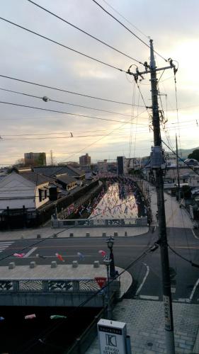 a view of a street with a crowd of people at Guest House Kuranomachi ゲストハウス蔵の街 in Tochigi