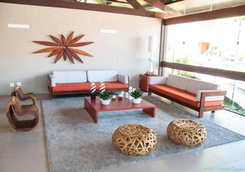a living room with two couches and a table at Apto Oka Beach Residence in Porto De Galinhas