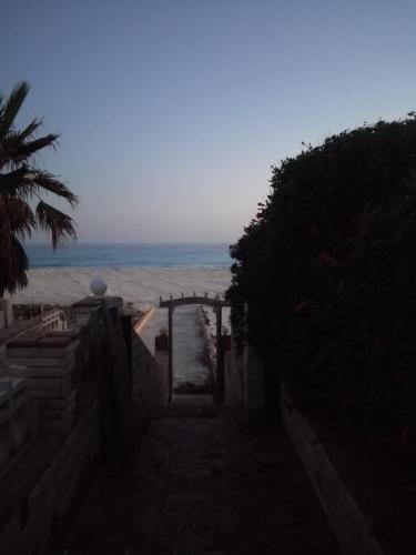a stairway to the beach with the ocean in the background at Riviera Dream Chalet in Dawwār al Ḩajj Aḩmad