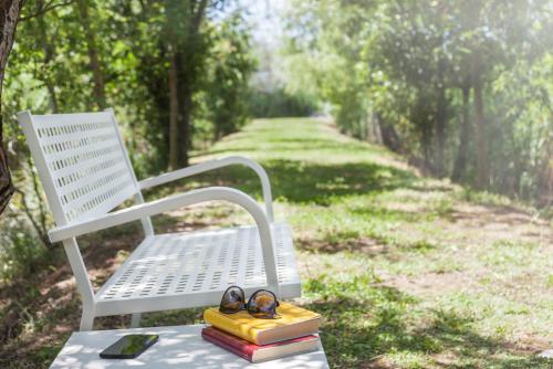 a bench with a pair of glasses and some books at Hotel Le Rotonde in Massaciuccoli