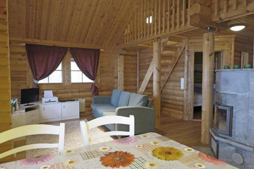 a living room with a couch and a table in a cabin at Villa Nina in Luikonlahti