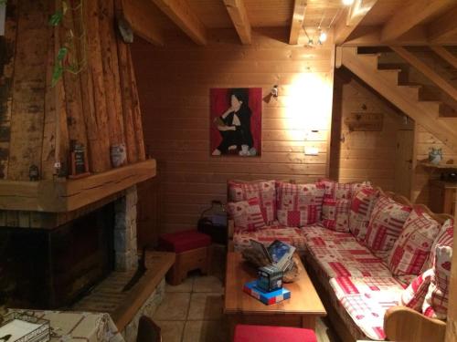 a living room with a couch and a fireplace at La Grange De L'Errance in Giron