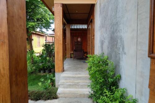 a hallway leading to a house with a porch at Baan Aew Pai in Pai