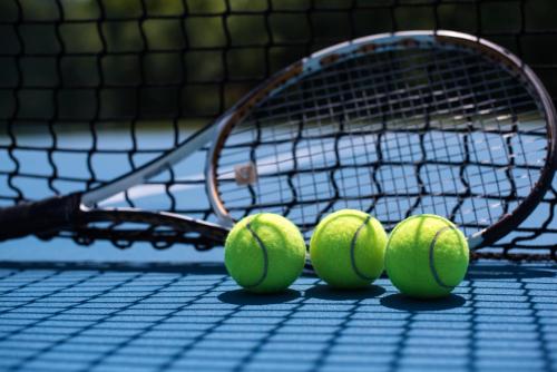 a group of four tennis balls on a tennis court at Holiday Resort Zlatni Dol Mostar in Goranci