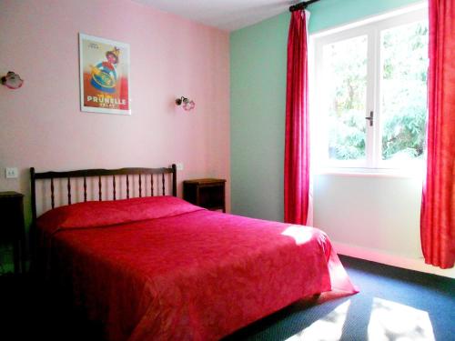 a bedroom with a red bed and a window at Hotel Restaurant du Moulin de Barette in Blavozy
