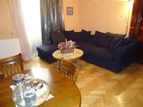 a living room with a couch and a table at Apartment Jafa in Tbilisi City