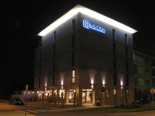 a building with a lit up sign on top of it at Hotel Blue Bratislava in Bratislava